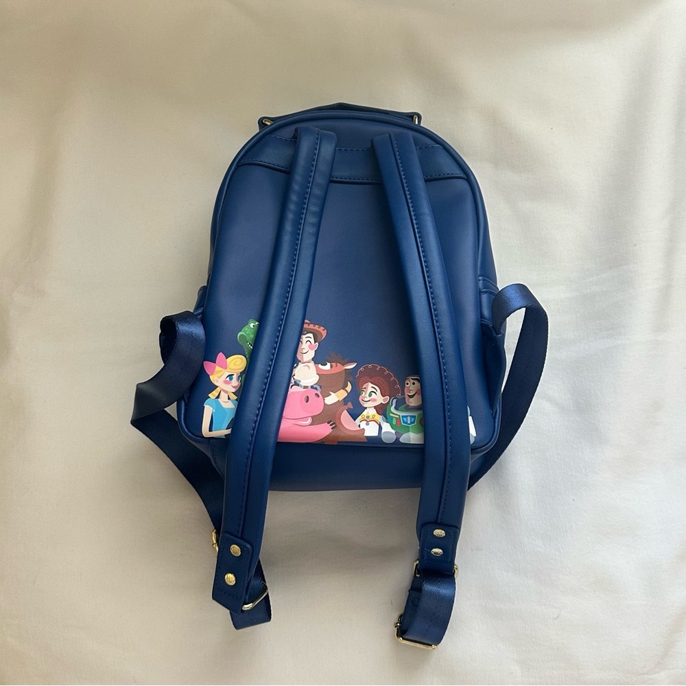 LOUNGEFLY PIXAR MOMEMT TOY STORY WOODY, BO PEEP, & TOYS BACKPACK - Picture 2 of 9